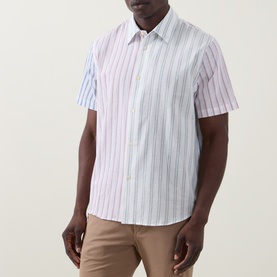 Model wearing Paul Smith White Stripes casual shirt with multicolour vertical stripes, short sleeves, styled with beige chinos.