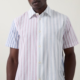 Model wearing Paul Smith Casual Shirt in white with multicolour pink and blue vertical stripes, short sleeves and classic collar.
