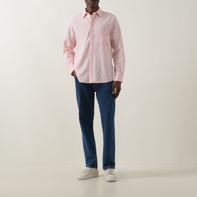 Model wearing Paul Smith pink casual shirt with chest pocket, styled with navy jeans and white trainers