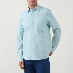 Model wearing Paul Smith Textured Stripe Shirt in green, long sleeves, chest pocket, styled with blue jeans