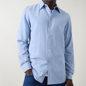 Model wearing Paul Smith Single-Cuff Shirt in blue, pointed collar, button fastening, long sleeves, styled with dark jeans.