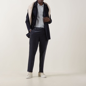 Model wearing Paul Smith white casual shirt, styled with navy blazer, tailored trousers, and white trainers.