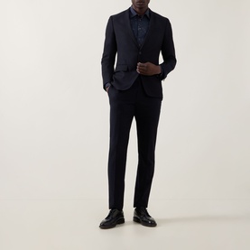 Model wearing Paul Smith Casual Abstract Print Shirt in navy, styled with a matching navy suit and black leather shoes.