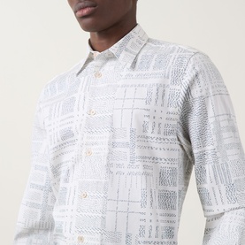 Model wearing Paul Smith white casual shirt with tonal geometric patchwork print, long sleeves and classic collar