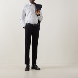 Model wearing Paul Smith white casual shirt with subtle check pattern, styled with black trousers and leather shoes, holding navy jacket