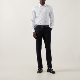 Model wearing Paul Smith Casual Abstract Print Shirt in white with dark abstract print, styled with black slim trousers and black leather shoes.