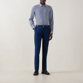 Model wearing Paul Smith blue casual shirt with white geometric print, styled with navy trousers and black leather shoes
