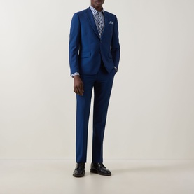 Model wearing Paul Smith blue casual shirt, styled with a blue tailored suit and dark leather Oxford shoes