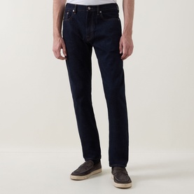 Model wearing Paul Smith Mid-Rise Slim Fit Tapered Leg Jeans in grey, styled with grey loafers. Five-pocket design with belt loops.