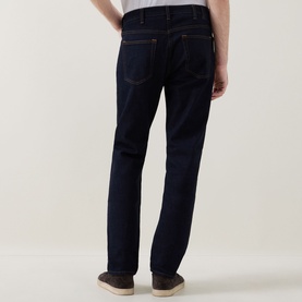 Model wearing Paul Smith Mid-Rise Slim Fit Tapered Leg Jeans in grey, rear view, five-pocket style with belt loops, styled with tan shoes.