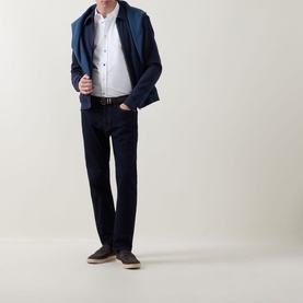 Model wearing Paul Smith Mid-Rise Slim Fit Tapered Leg Jeans in grey, styled with a navy jacket, white shirt, and dark loafers.
