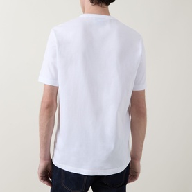Model wearing Paul Smith white crew neck T-shirt, back view, styled with dark denim jeans