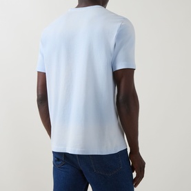 Model wearing Paul Smith Logo Faded T-Shirt in blue, back view, crew neck, short sleeves, styled with dark blue jeans.