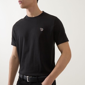 Model wearing Paul Smith black cotton crew neck T-shirt with embroidered zebra logo patch, styled with a black belt.