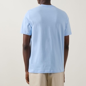 Model wearing Paul Smith blue crew neck T-shirt, back view, styled with beige trousers.