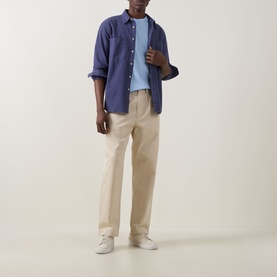 Model wearing Paul Smith Blue Crew Neck T-shirt, styled with navy overshirt, beige chinos and white trainers.