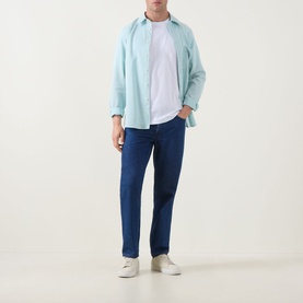 Model wearing Paul Smith White Crew Neck T-shirt, styled with a light blue overshirt and dark blue jeans, white trainers
