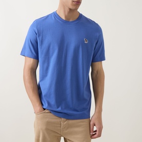 Model wearing Paul Smith Zebra Badge T-Shirt in blue, crew neck with short sleeves and small zebra logo badge on chest, styled with beige trousers