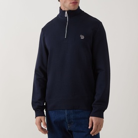 Model wearing Paul Smith Zebra Logo Half-Zip Sweatshirt in blue, with stand collar and chest zebra logo, styled with blue jeans