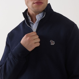 Model wearing Paul Smith Zebra Logo Half-Zip Sweatshirt in blue with stand collar, styled with striped shirt underneath