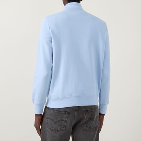Model wearing Paul Smith Zebra Logo Half-Zip Sweatshirt in blue, rear view, with ribbed trims and funnel neck, styled with grey jeans.