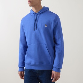 Model wearing Paul Smith blue cotton hoodie with zebra logo patch, kangaroo pocket and drawstring hood, styled with dark jeans