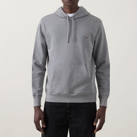 Model wearing Paul Smith Zebra Logo Drawstring Hoodie in grey with pouch pocket, styled with black jeans