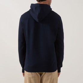 Model wearing Paul Smith Zebra Logo Hoodie in blue, rear view, with khaki trousers. Kangaroo pocket and ribbed hem visible.