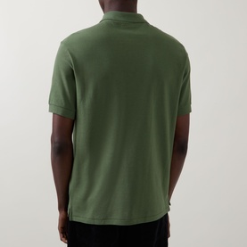 Model wearing Paul Smith green cotton polo shirt, rear view, short sleeves, ribbed collar