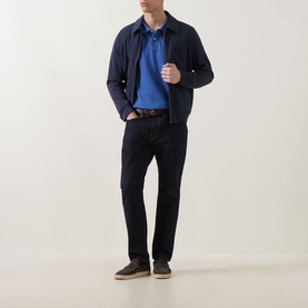 Model wearing Paul Smith Blue Cotton Polo with navy harrington jacket, dark trousers, brown belt and grey suede loafers.