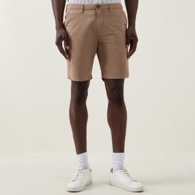 Model wearing Paul Smith Regular Fit Twill Chino Shorts in brown with white trainers and socks.