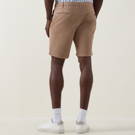 Model wearing Paul Smith Regular Fit Twill Chino Shorts in brown, rear view, styled with white trainers and white socks.