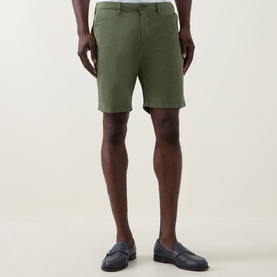 Model wearing Paul Smith Regular Fit Twill Chino Shorts in green, styled with navy leather loafers.