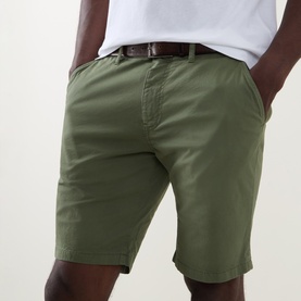 Model wearing Paul Smith Regular Fit Twill Chino Shorts in green with brown leather belt and white T-shirt.