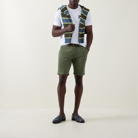 Model wearing Paul Smith Regular Fit Twill Chino Shorts in green, styled with a white tee and patterned vest, navy loafers.