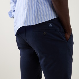 Model wearing Paul Smith Regular Fit Twill Chino Shorts in blue, styled with a light blue striped shirt. Close-up rear view showing belt loops and