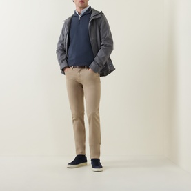 Model wearing Paul Smith Slim Tapered Jeans in brown with a navy jacket, blue jumper and navy suede shoes.
