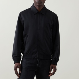 Model wearing Calvin Klein black casual jacket with zip fastening, spread collar, and ribbed cuffs, styled with black trousers