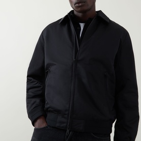 Model wearing Calvin Klein black casual jacket with zip fastening, ribbed cuffs and hem, styled over white crew-neck tee