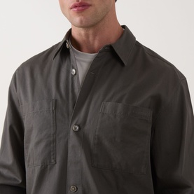 Model wearing Calvin Klein Garment Wash Twill Shirt in Beluga, showing point collar, front button placket and chest patch pockets