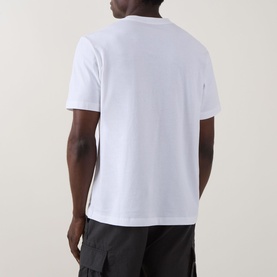 Model wearing Calvin Klein 20S SPW Graphic Logo T-Shirt in Bright White, crew neck, short sleeves, styled with black cargo trousers, rear view.