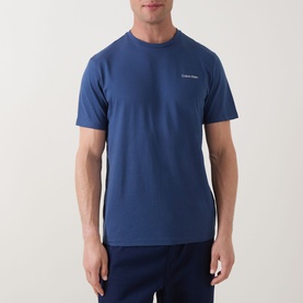 Model wearing Calvin Klein Micro Logo T-Shirt in Dark Denim, crew neck, short sleeves, with small chest logo print