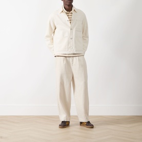 Model wearing Samsoe & Samsoe Chore Denim Jacket in Soft Natural with matching wide-leg trousers and brown shoes.