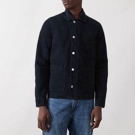 Model wearing Samsoe & Samsoe New Worker Denim Jacket in Salute, featuring pointed collar, white buttons, and patch pockets, styled with blue jeans.