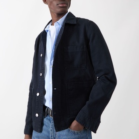 Model wearing Samsoe & Samsoe New Worker Denim Jacket in Salute, dark navy cotton with pointed collar and patch pockets, styled with light blue shirt