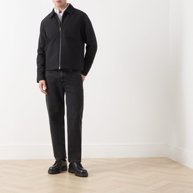 Model wearing Samsoe & Samsoe Robin Zip-Up Jacket in black with cord collar, styled with dark trousers and black leather shoes.