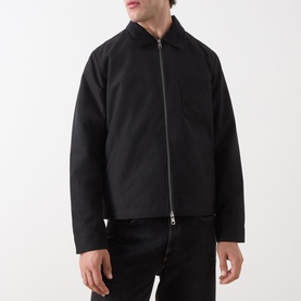 Model wearing Samsoe & Samsoe Robin Zip-Up Jacket in black, featuring cord collar and two-way zip, styled with black jeans.
