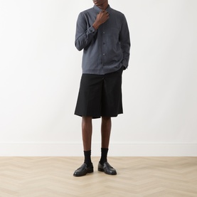 Model wearing Samsoe & Samsoe Salute Mel casual shirt, styled with black shorts, socks and loafers.