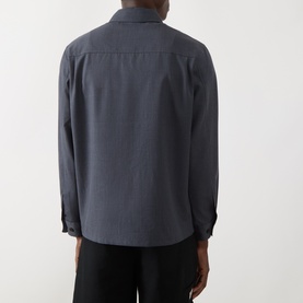 Model wearing Samsoe & Samsoe Salute Mel casual shirt, rear view, long sleeves, styled with black trousers.