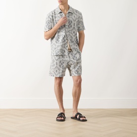 Model wearing Samsoe & Samsoe Salute Symmetry casual shirt with matching shorts and dark brown slide sandals